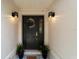 Inviting front door with decorative wreath, stylish lighting, and potted plants, enhancing curb appeal at 2644 Sw 20 Cir, Ocala, FL 34471