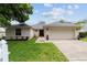 Charming single-story home with a well-manicured lawn, attached garage, and a freshly painted exterior at 2644 Sw 20 Cir, Ocala, FL 34471