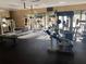 An exercise room featuring a variety of weight machines and a black rubber floor at 2644 Sw 20 Cir, Ocala, FL 34471