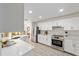 Well-lit kitchen with quartz countertops, stainless appliances, open layout to the dining room at 2644 Sw 20 Cir, Ocala, FL 34471