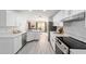 Open-concept kitchen boasts quartz countertops, stainless steel appliances, and views of the dining area at 2644 Sw 20 Cir, Ocala, FL 34471