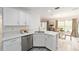 Stylish kitchen offers white cabinets, stainless steel appliances, and quartz countertops at 2644 Sw 20 Cir, Ocala, FL 34471
