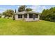 Exterior angle of enclosed sunroom with a door to the green backyard at 2644 Sw 20 Cir, Ocala, FL 34471