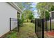 Backyard featuring a black fence and a gate that leads to the community greenspace at 32 Hickory Course Loop, Ocala, FL 34472