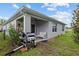 Back of home with outdoor kitchen, fenced yard and covered patio at 32 Hickory Course Loop, Ocala, FL 34472