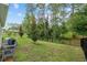 Beautiful backyard with lush grass and a black metal fence at 32 Hickory Course Loop, Ocala, FL 34472