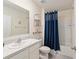 Well-lit bathroom featuring a tub-shower combo, modern fixtures, and decorative shelving at 32 Hickory Course Loop, Ocala, FL 34472