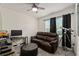 Bedroom area featuring a large screen television, comfortable seating and a ceiling fan at 32 Hickory Course Loop, Ocala, FL 34472