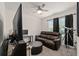Bedroom area featuring a large screen television, comfortable seating and a ceiling fan at 32 Hickory Course Loop, Ocala, FL 34472