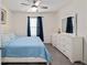 Bedroom featuring a comfortable bed, stylish dresser, and bright natural light from the window at 32 Hickory Course Loop, Ocala, FL 34472