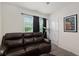 Bedroom area featuring a large screen television, comfortable seating and a ceiling fan at 32 Hickory Course Loop, Ocala, FL 34472