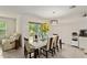 Dining room with a contemporary table setting, a modern chandelier, and a glass slider to the backyard at 32 Hickory Course Loop, Ocala, FL 34472