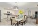 Bright dining area featuring a modern table set and an open view to the kitchen at 32 Hickory Course Loop, Ocala, FL 34472
