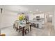 Dining room with a modern table and seating adjacent to the kitchen and additional seating at the kitchen island at 32 Hickory Course Loop, Ocala, FL 34472