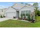 Beautifully landscaped home featuring a two car garage at 32 Hickory Course Loop, Ocala, FL 34472