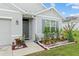Inviting front entrance with lush landscaping and a well-maintained lawn at 32 Hickory Course Loop, Ocala, FL 34472