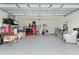 Spacious garage with epoxy floors, storage racks and ample room for two vehicles at 32 Hickory Course Loop, Ocala, FL 34472
