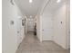 Hallway view featuring tile flooring and multiple doorways at 32 Hickory Course Loop, Ocala, FL 34472