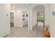 Hallway view with tile flooring leading to the laundry room and living area at 32 Hickory Course Loop, Ocala, FL 34472