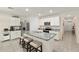 Modern kitchen featuring granite countertops, stainless appliances, an island with seating, and ample white cabinets at 32 Hickory Course Loop, Ocala, FL 34472