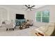 Inviting living room featuring a ceiling fan, comfortable seating, and an exterior view at 32 Hickory Course Loop, Ocala, FL 34472