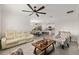 Open-concept living space features comfortable seating and a view into the kitchen and dining area at 32 Hickory Course Loop, Ocala, FL 34472