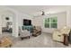 Cozy living room with a ceiling fan, comfortable seating and lots of natural light at 32 Hickory Course Loop, Ocala, FL 34472