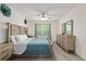 Well-lit main bedroom features a double dresser and bright window with plenty of natural light at 32 Hickory Course Loop, Ocala, FL 34472
