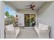 Covered outdoor patio with ceiling fan and patio furniture at 32 Hickory Course Loop, Ocala, FL 34472