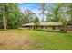 A spacious backyard features a covered porch and lush landscaping around the home at 3331 Se 4Th St, Ocala, FL 34471