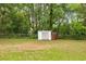 Spacious backyard featuring a storage shed, mature trees, and green grass at 3331 Se 4Th St, Ocala, FL 34471