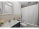 Well-lit bathroom featuring a bathtub with shower, white vanity and wainscoting at 3331 Se 4Th St, Ocala, FL 34471