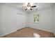 A bright bedroom features a window, closet, ceiling fan, and carpeted floors at 3331 Se 4Th St, Ocala, FL 34471