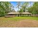 Charming single-story home with green exterior, well-maintained lawn, and mature trees at 3331 Se 4Th St, Ocala, FL 34471