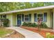 Welcoming front entrance with a decorative door and neat landscaping that adds to the home's charm at 3331 Se 4Th St, Ocala, FL 34471