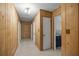 Hallway featuring wood paneling and access to a bathroom at 3331 Se 4Th St, Ocala, FL 34471