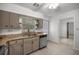 Bright kitchen featuring neutral cabinetry, stainless dishwasher, and tile flooring at 3331 Se 4Th St, Ocala, FL 34471