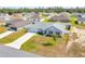 Aerial view of a well-kept home with an attached garage, green lawn, and mature trees at 3418 Sw 155Th Pl, Ocala, FL 34473