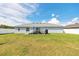 Spacious backyard with a white fence, patio furniture under an umbrella, and green grass at 3418 Sw 155Th Pl, Ocala, FL 34473