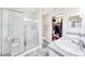 The bathroom has double sinks, a glass enclosed shower, gray tile floors, and a walk-in closet at 3418 Sw 155Th Pl, Ocala, FL 34473