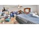 This bedroom has neutral walls and carpet, with a ceiling fan and a large dresser at 3418 Sw 155Th Pl, Ocala, FL 34473