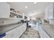 Bright, streamlined kitchen features white cabinetry, gray countertops, and stainless-steel appliances at 3418 Sw 155Th Pl, Ocala, FL 34473