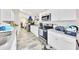 Efficient kitchen features white cabinets, gray countertops, tile backsplash, and stainless steel appliances at 3418 Sw 155Th Pl, Ocala, FL 34473