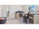 Another view of the office space with a desk, chair, and natural light streaming through the window at 3418 Sw 155Th Pl, Ocala, FL 34473