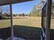 View from the covered porch showing the expansive backyard and natural landscape at 360 Marion Oaks Golf Way, Ocala, FL 34473