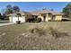 Beautiful yellow single-Gathering home with mature landscaping and a well-manicured lawn at 360 Marion Oaks Golf Way, Ocala, FL 34473