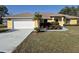 Charming yellow single-Gathering home with well-maintained landscaping and a spacious driveway at 360 Marion Oaks Golf Way, Ocala, FL 34473