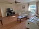 Inviting living room features wood flooring, a large window, and comfortable seating at 360 Marion Oaks Golf Way, Ocala, FL 34473