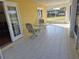 Screened in patio with tile floors and seating for enjoying the outdoors at 360 Marion Oaks Golf Way, Ocala, FL 34473