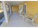Enclosed patio with tile floors and a charming seating area, perfect for relaxation and outdoor dining at 360 Marion Oaks Golf Way, Ocala, FL 34473